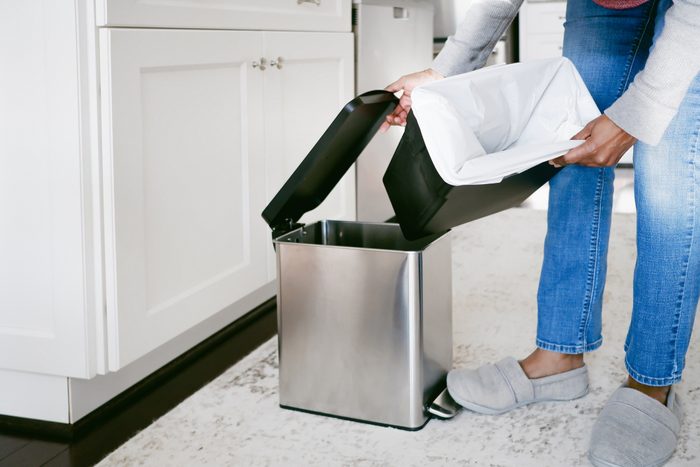 Woman Replaces Kitchen Trash Bag