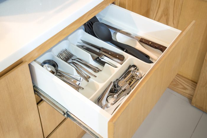 Open kitchen drawer with silverware