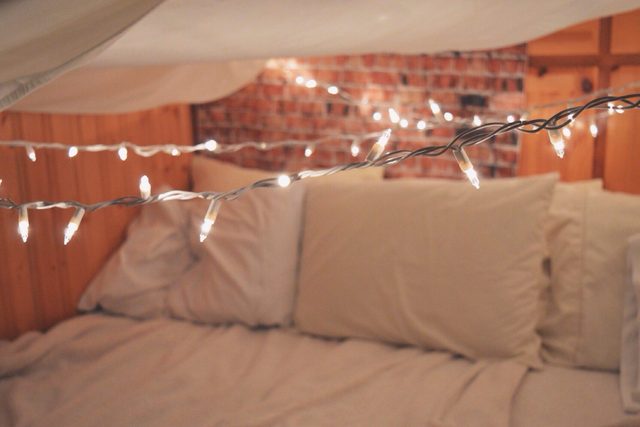 Illuminated String Lights Over Bed At Home