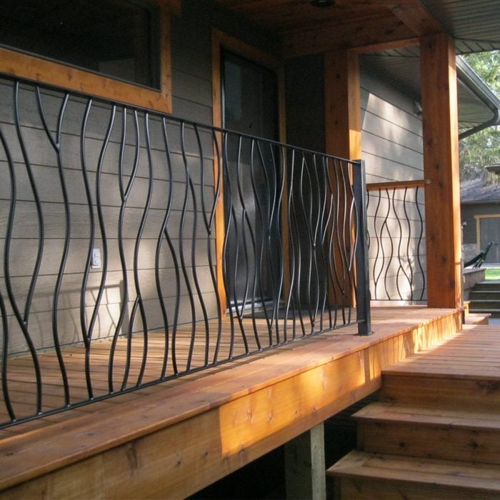 custom Bent Iron Deck Railing on a front porch and steps