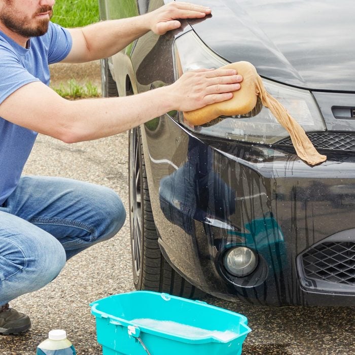man washing his car with the Car Wash Sponge Inside Nylon Stocking