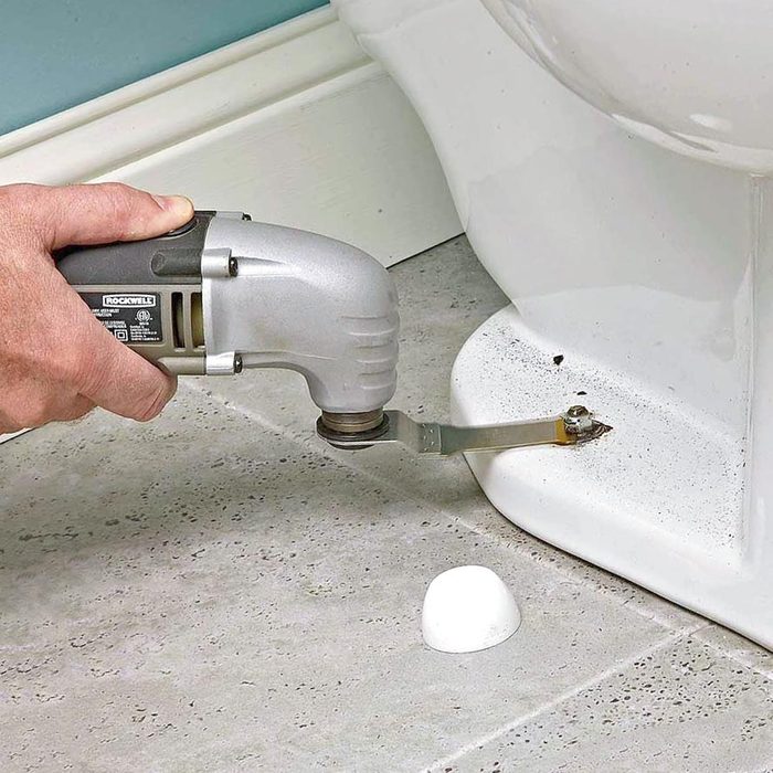 Cutting off corroded bolts from a toilet with an oscillating tool
