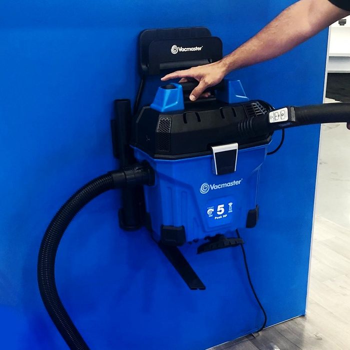 a blue vac master vacuum on a blue wall at the National Hardware Show