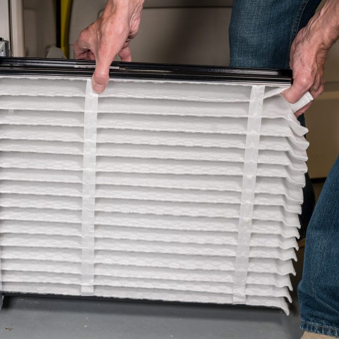 Midsection Of Man Holding Air Filter