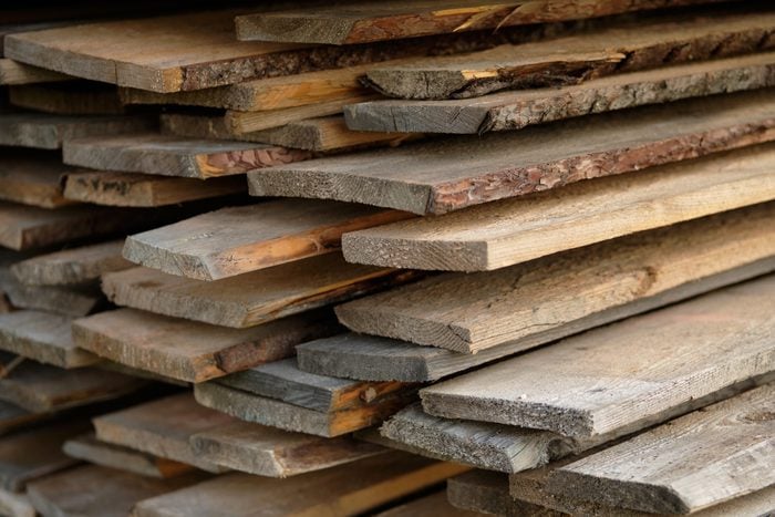 stacks of reclaimed wood boards for sale