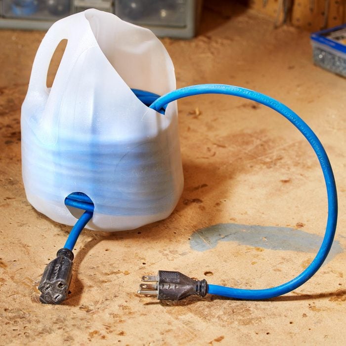 Milk Jug with holes holds a blue Cord inside