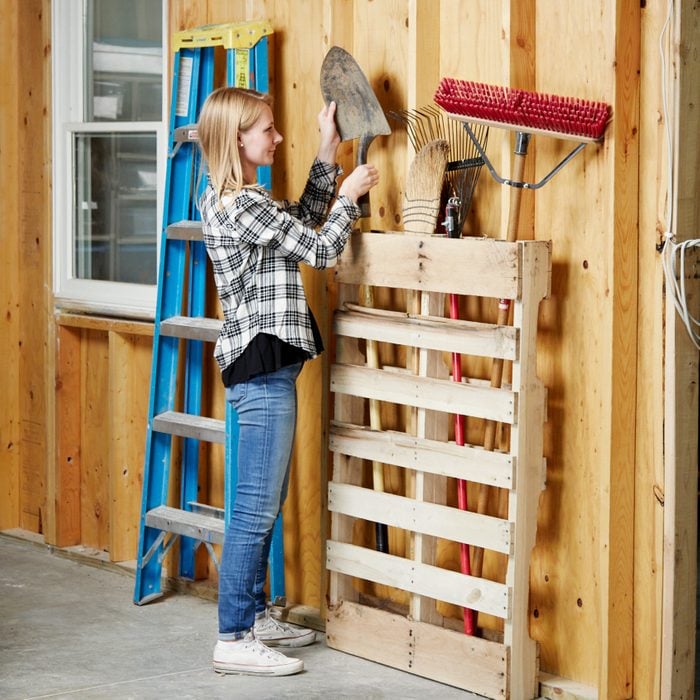 up cycled pallet into yard tool organizer
