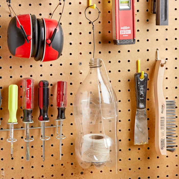 recycled bottle to hold string in a workshop