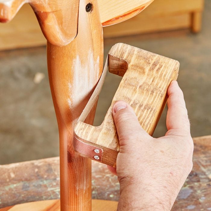 close up of a Custom Sanding Bow sanding a chair leg