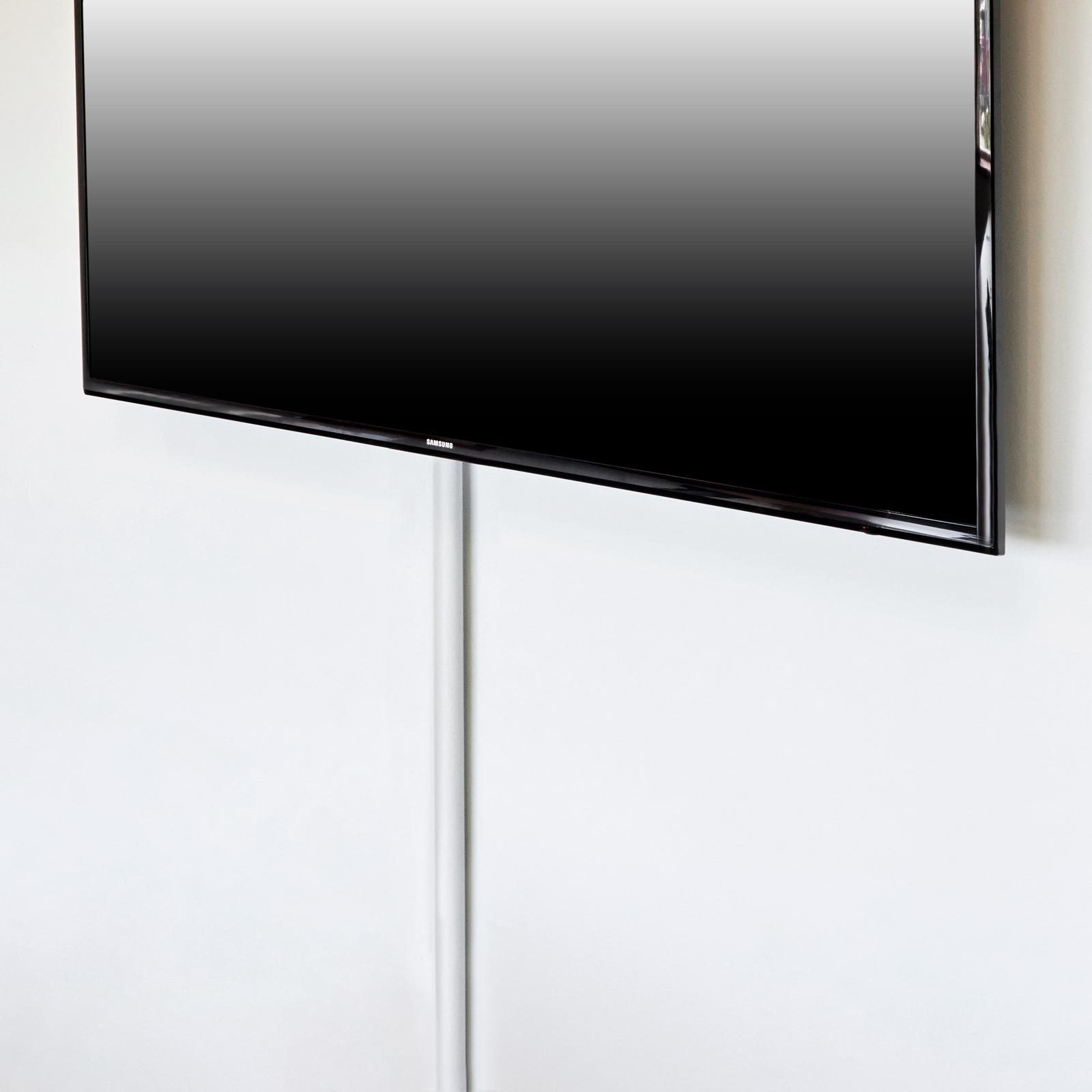 using a curtain rod to hide wires for a wall mounted flat screen TV