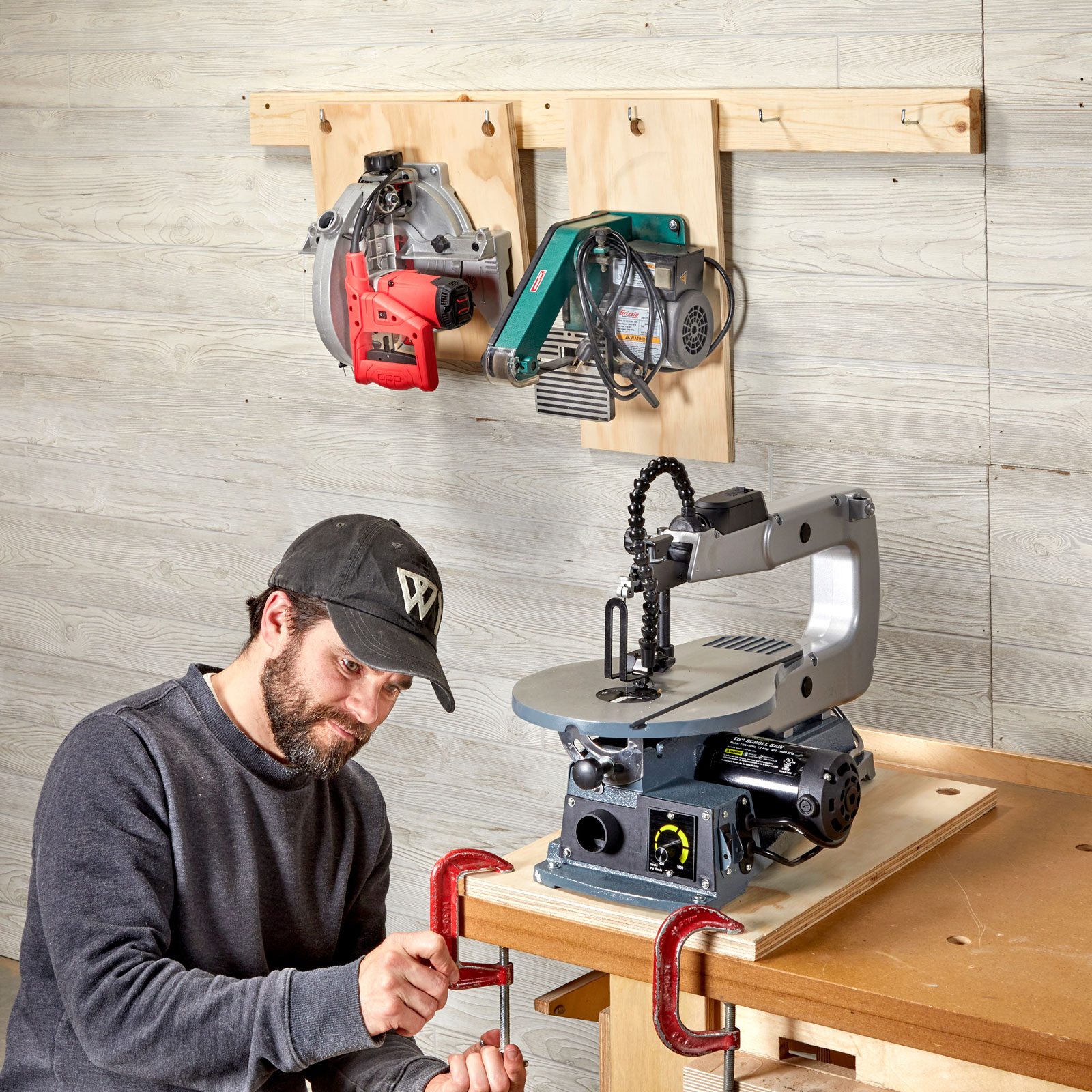 man with clamps and table saw