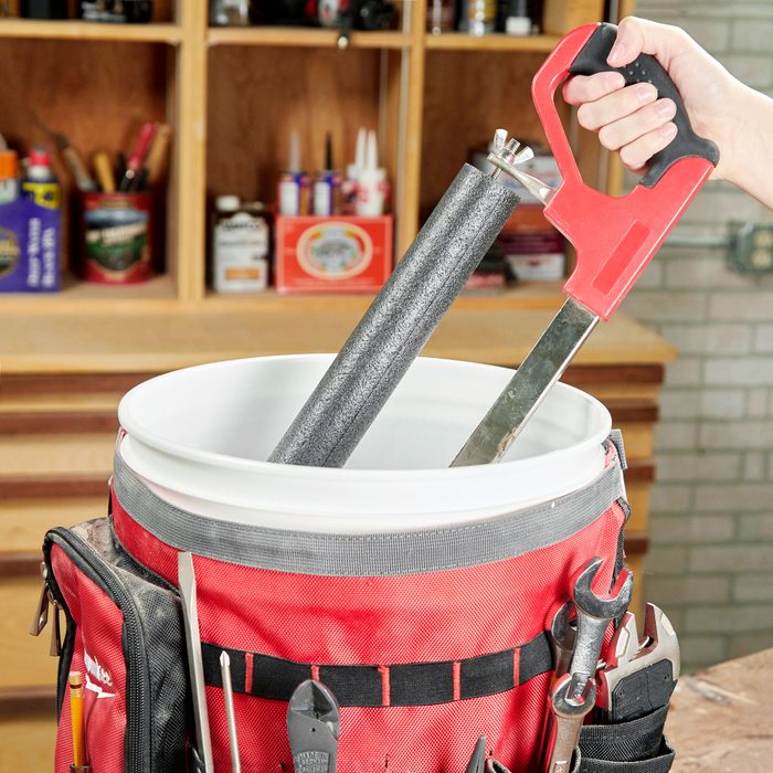 using a bucket to store hacksaw and other tools