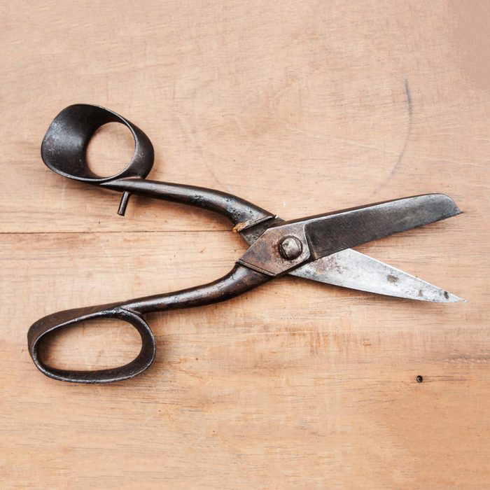 old scissors on a wooden background