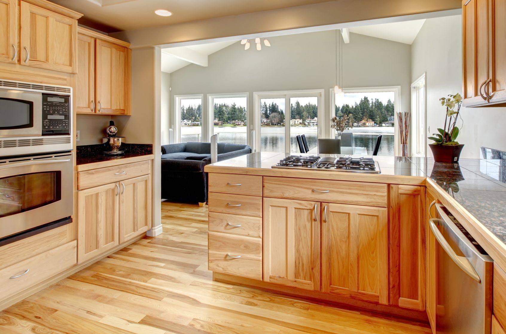 Bright wood kitchen with hickory hardwood floors and dining area