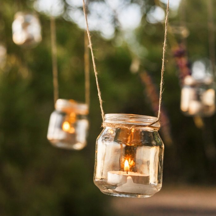 mason jar candle hanging on tree for wedding decor