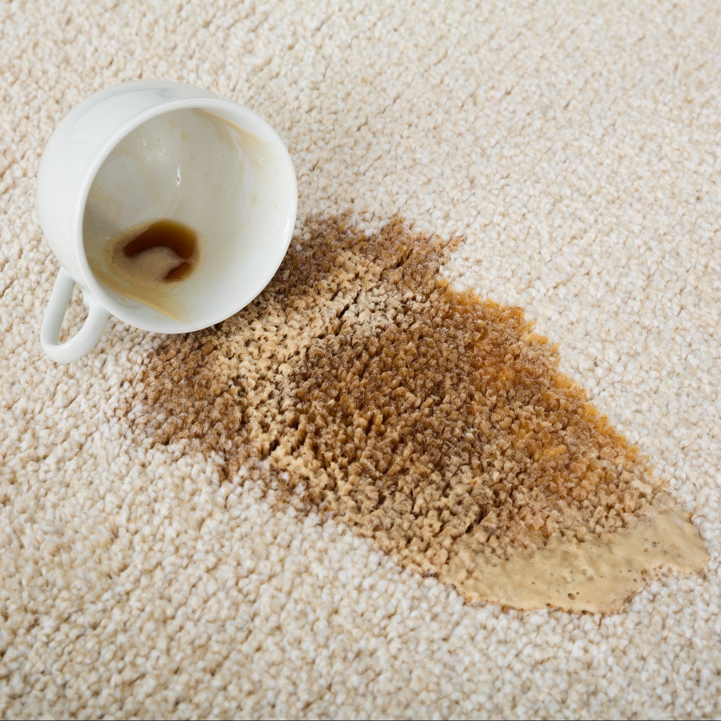 Coffee Spilling From Cup On Carpet