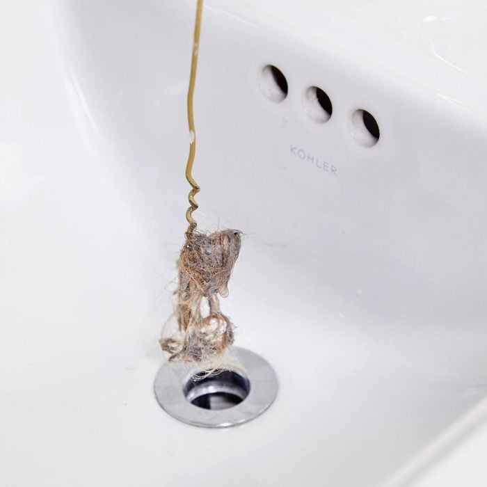 using a hanger to unclog a clogged bathroom sink drain