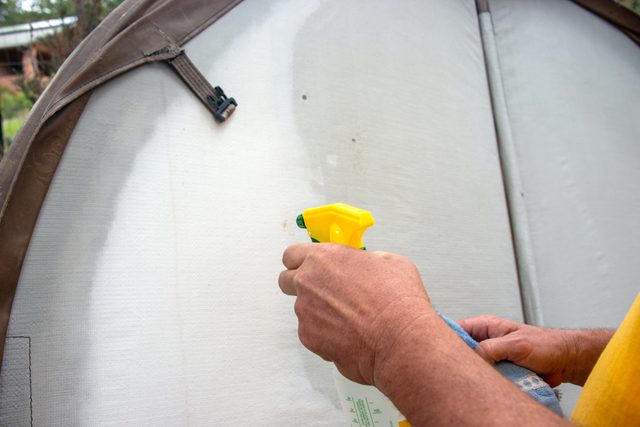 using spray cleaner to clean the hot tub cover