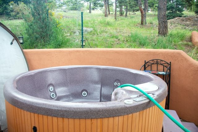 filling a hot tub with a hose after being cleaned
