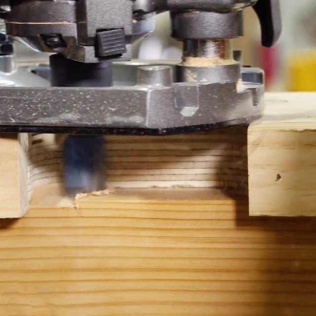 close up of a router with a piece of wood