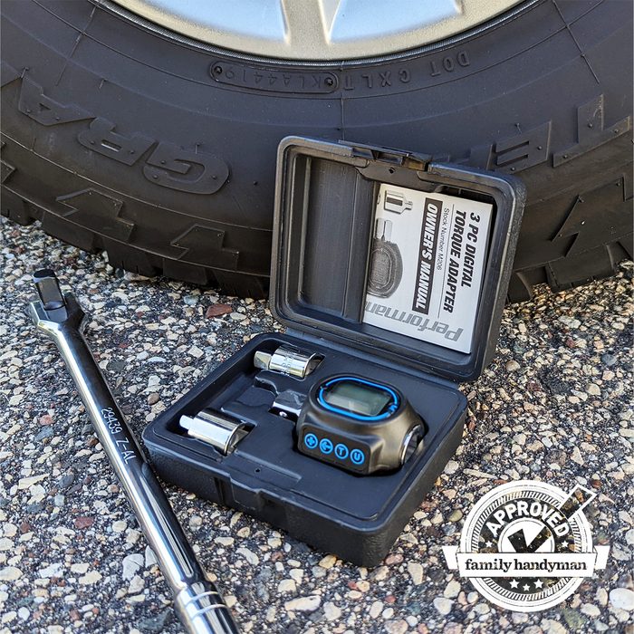 Performance Tool Digital Torque Adapter sitting outside next to a tire