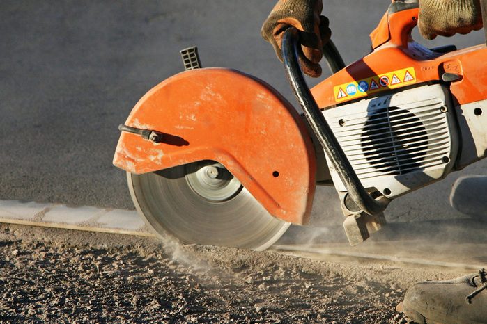 man cutting concrete