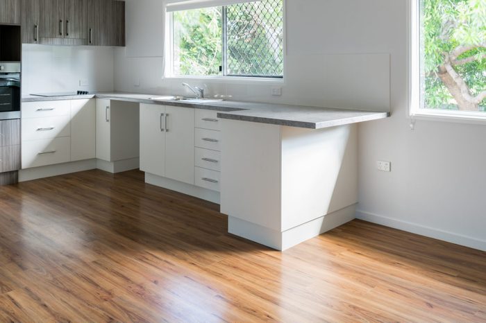 New bright white and gray kitchen with a luxury vinyl plank floor