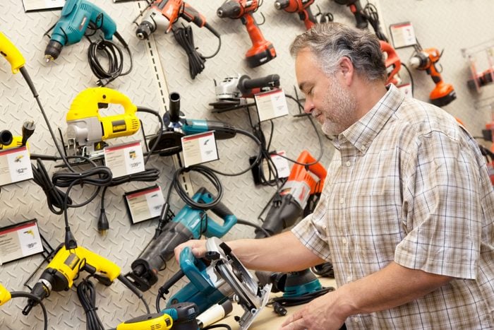 man observing power tools from different manufacturers