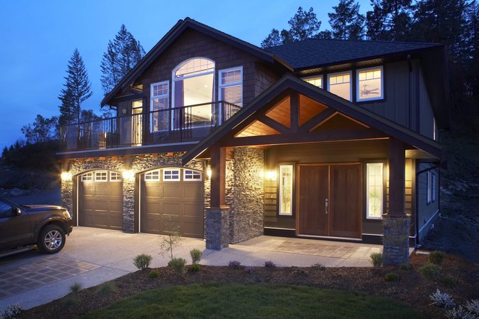 Modern house with car parked on drive, dusk