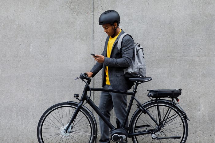 a man standing next to an e-bike In the city