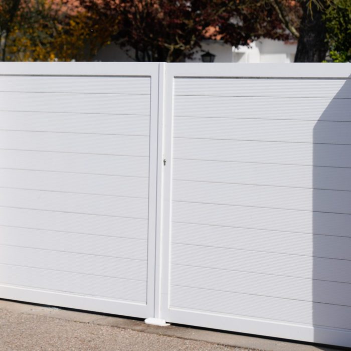 white vinyl privacy fence in a neighborhood