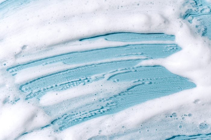 shaving cream foam on blue glass background