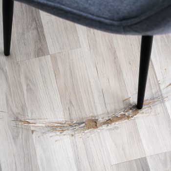 gouge in vinyl plank Flooring from a chair