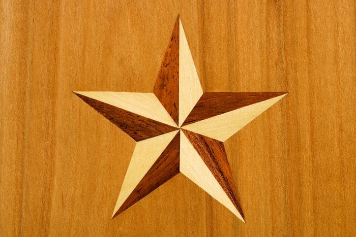 Intarsia, star out of nut tree and maple wood in cherrywood