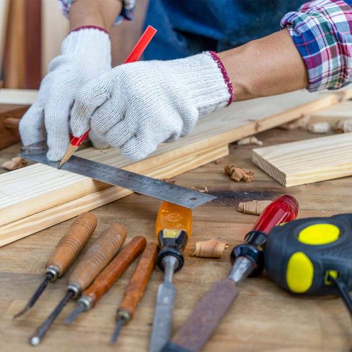 Gettyimages 1327237006 Carpenter Working, Hammer, Meter And Screw Driver On Construction Background