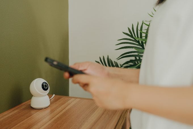anonymous person connecting to smart home security camera on their smartphone