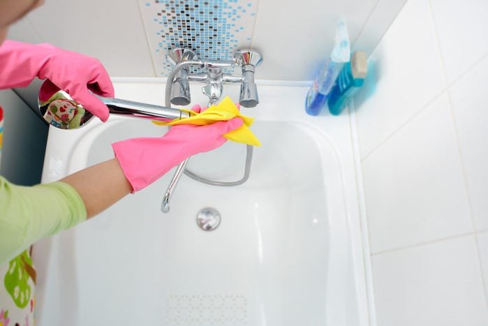 A Woman Cleaning Bathroom At Home