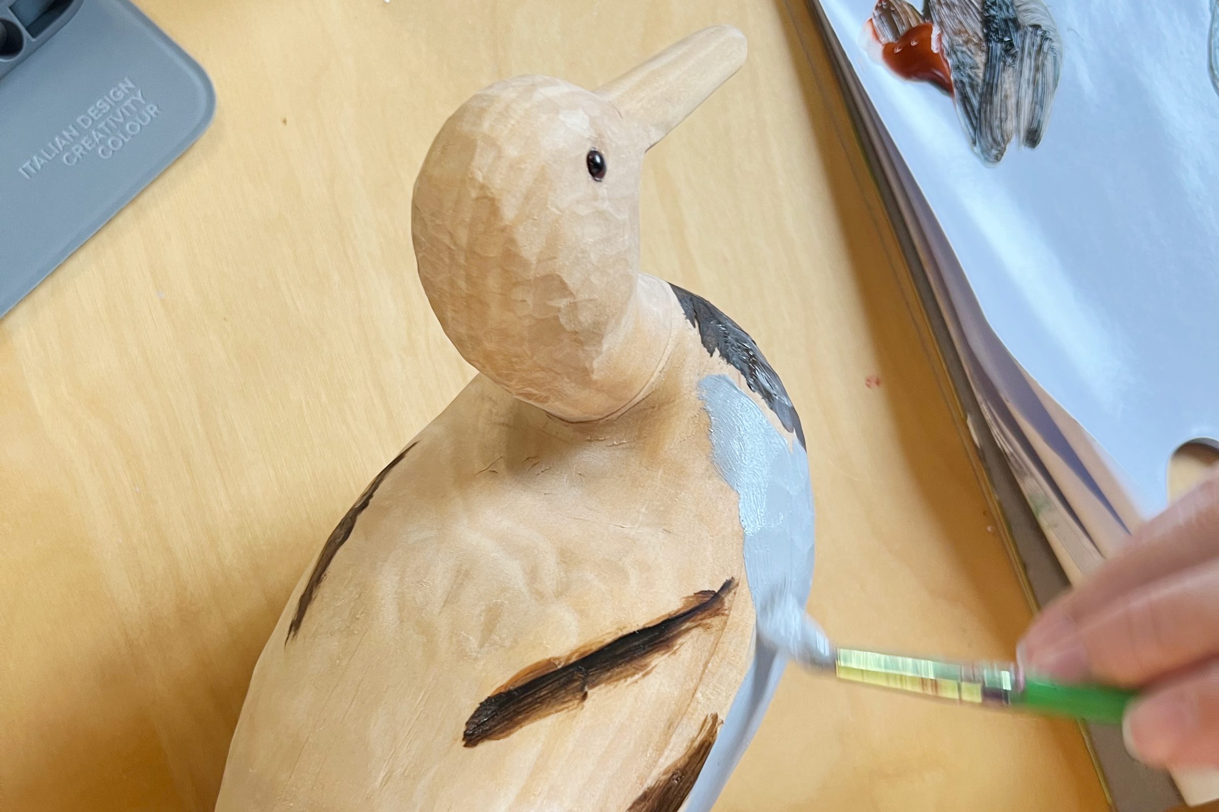 painting a wooden duck