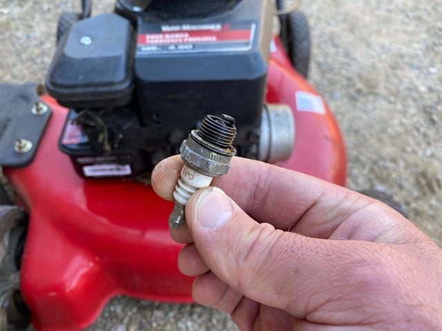 Determine if the spark plug needs cleaning or replacement