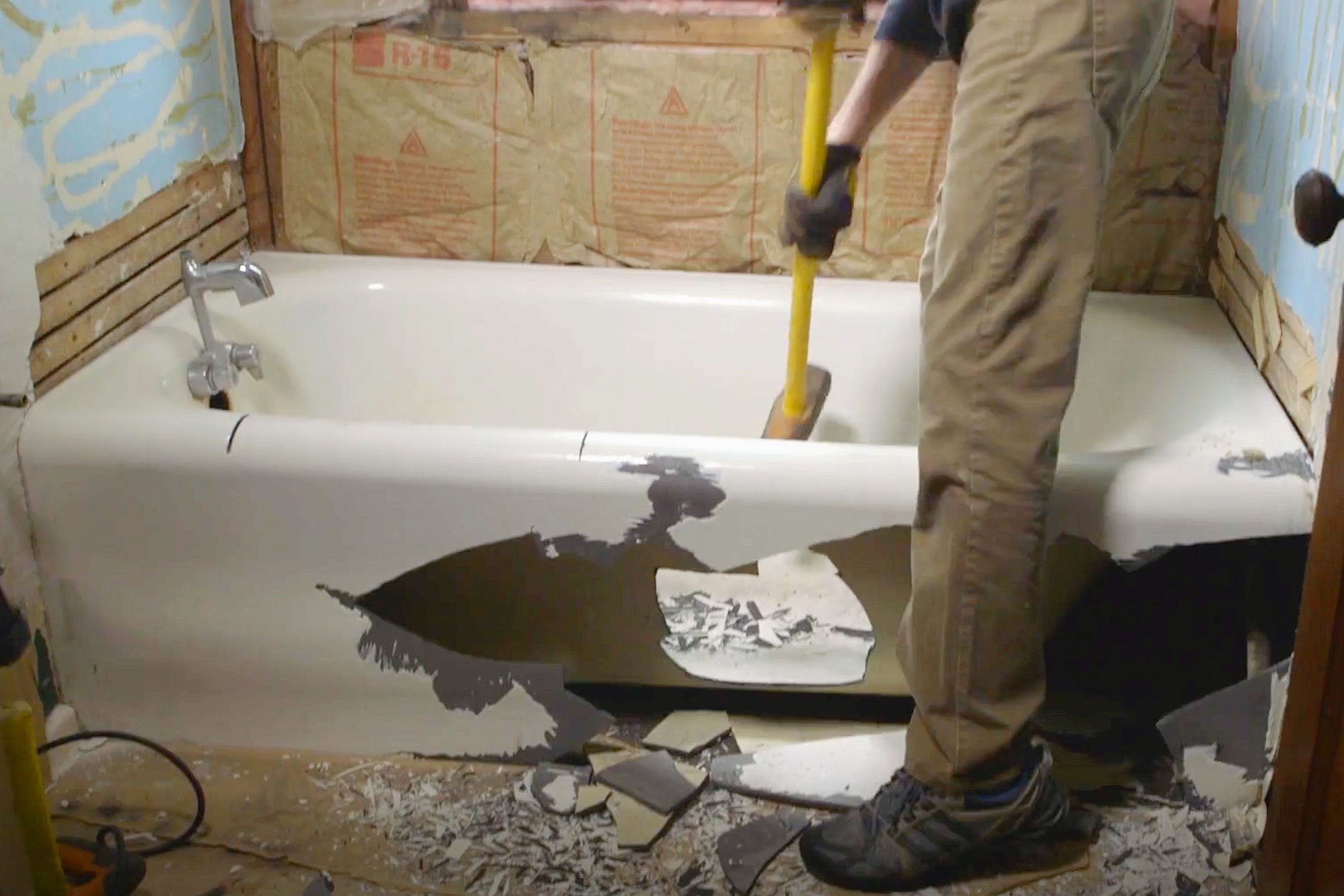 removing a cast iron bath tub with a sledge hammer