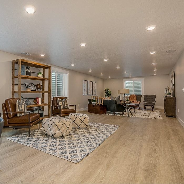 Wood flooring in basement rec room area with a lot of space