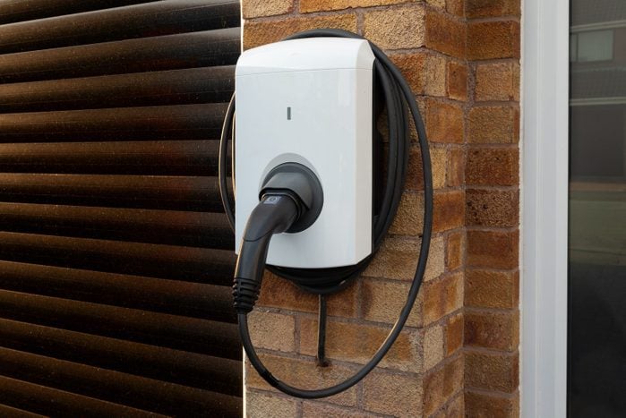 residential Electric Vehicle Charging Unit on a brick wall in a garage
