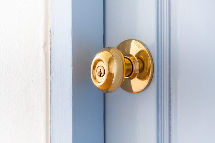 brass Metal Door Knob on a light blue door
