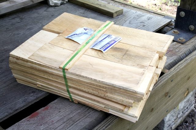 package of shingles outside on a wooden deck
