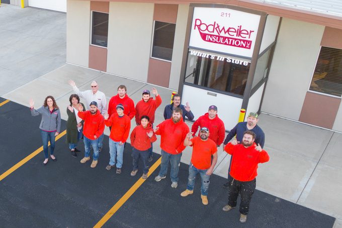 The Rockweiler Team Waving the parking lot outside their building