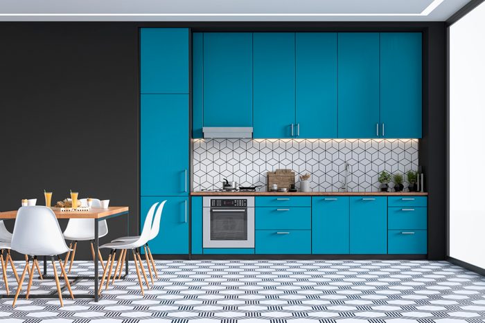 Modern kitchen and dining room on retro tiled floor
