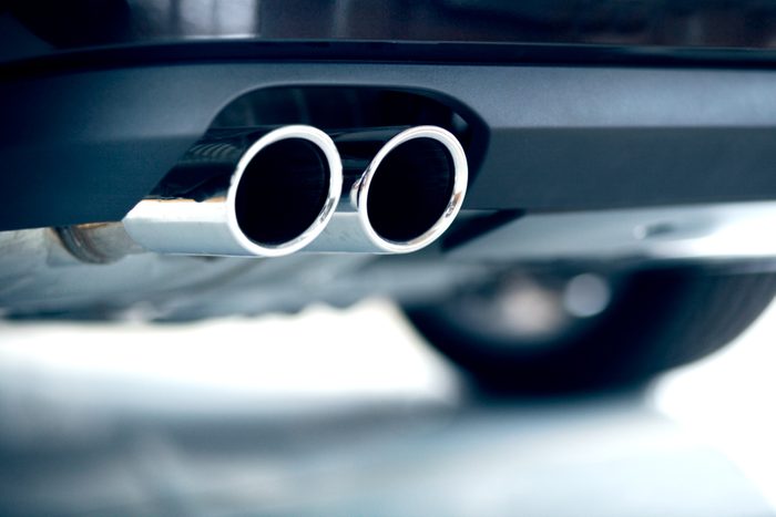 Stainless steel exhaust pipes on a blue car