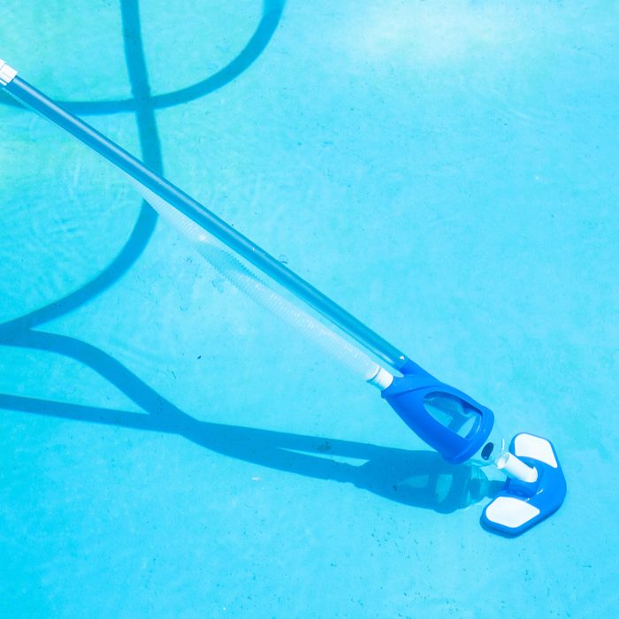 Cleaning Swimming Pool By Vacuum Cleaner