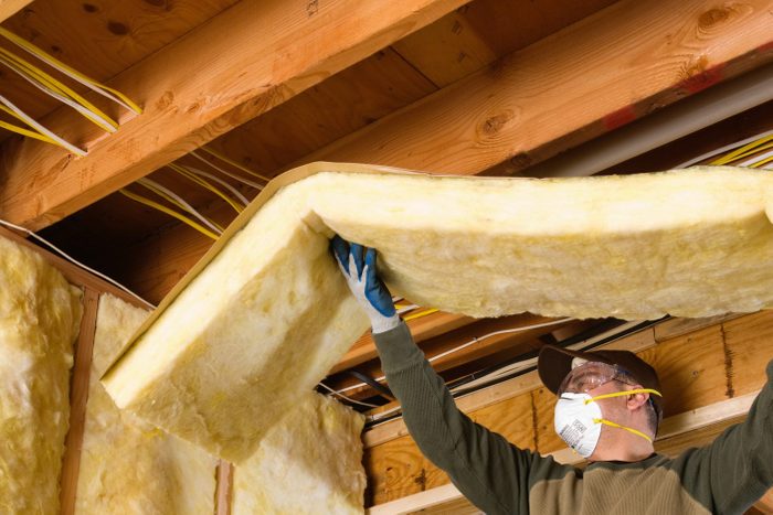 insulation being installed in basement ceiling