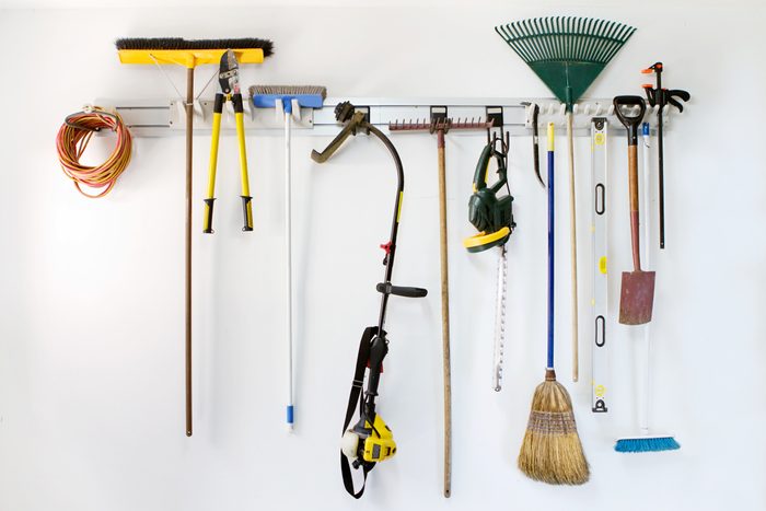 organized garage wall with tools hanging